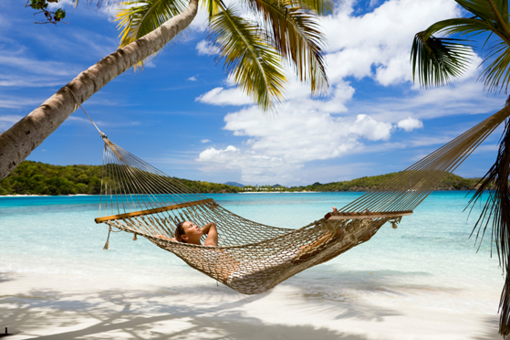 woman lying in hammock at the Caribbean beach